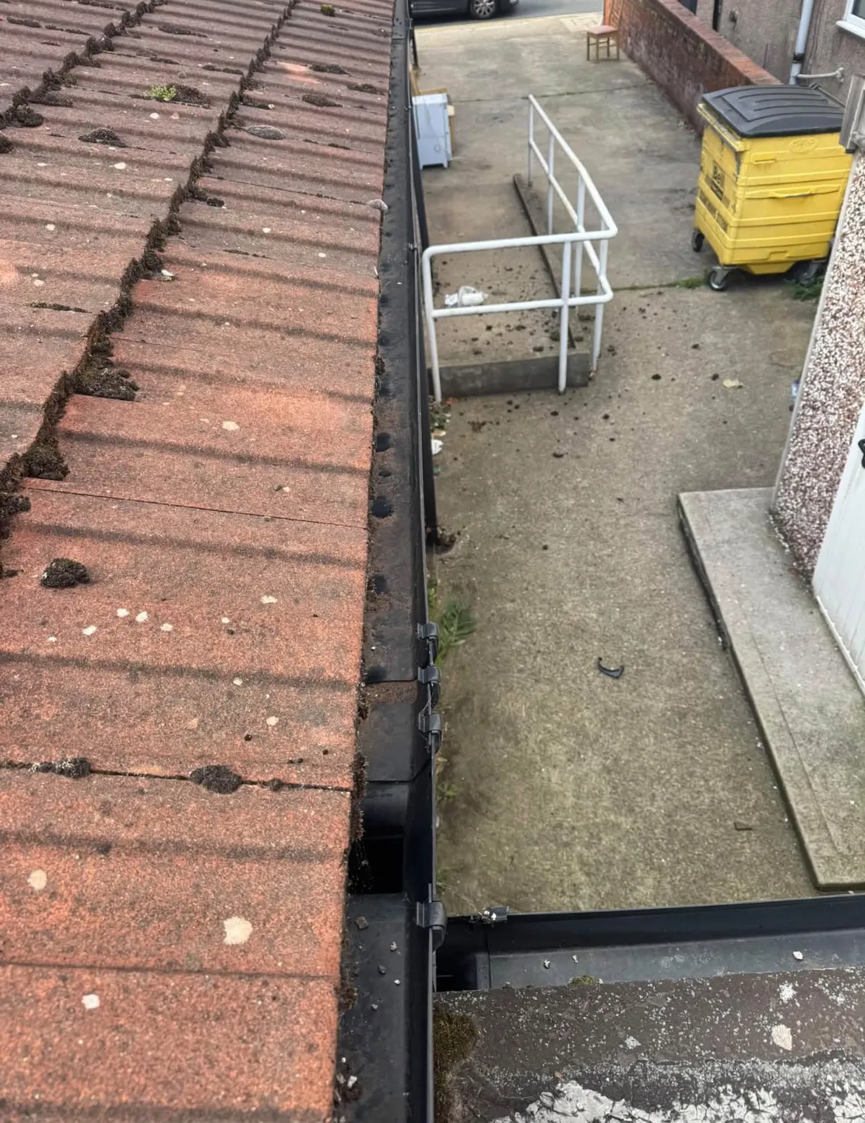 Gutter clearing on tiled roof